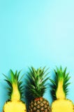 Pattern with bright pineapples on blue background. Top View. Copy Space. Minimal style. Pop art design, creative summer Royalty Free Stock Photo Pattern with bright pineapples on blue background. Top View. Copy Space. Minimal style. Pop art design, creative summer Royalty Free Stock Photo