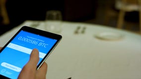 Payment by cryptocurrency in the restaurant using a tablet close up. Stock. Man sitting in internet caffe and going to royalty free stock image Payment by cryptocurrency in the restaurant using a tablet close up. Stock. Man sitting in internet caffe and going to royalty free stock image