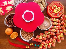 A peach-shaped candy box and the firecracker decorations on wooden brown background for the Ox year Lunar New Year