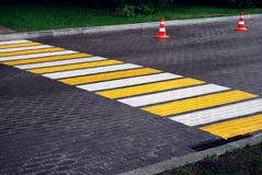 Pedestrian crossing and traffic cones on wet paved road stock photography Pedestrian crossing and traffic cones on wet paved road stock photography