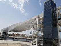 Pedestrian walkway with an original and unique twisted steel structure to allow pedestrians to cross Dubai canal royalty free stock photo Pedestrian walkway with an original and unique twisted steel structure to allow pedestrians to cross Dubai canal royalty free stock photo