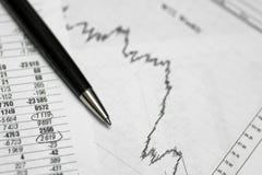 Pen on paper with the price quotes and charts stock image Pen on paper with the price quotes and charts stock image