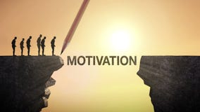 Pencil write 'MOTIVATION', connecting the cliff. Businessman crossing the cliff, business concept.
