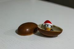 Penguin toy in the chocolate egg. Childhood in my heart. Kinder. Surprise stock photography Penguin toy in the chocolate egg. Childhood in my heart. Kinder. Surprise stock photography
