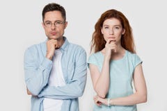 Pensive couple touch chin with finger thinking of something stock photos Pensive couple touch chin with finger thinking of something stock photos