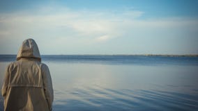The pensive man standing near the sea stock photo The pensive man standing near the sea stock photo