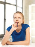 Pensive teenage girl with pen and paper stock photos Pensive teenage girl with pen and paper stock photos