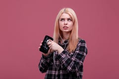 Pensive woman holding a stethoscope and a broken smartphone. On a pink background. royalty free stock photography Pensive woman holding a stethoscope and a broken smartphone. On a pink background. royalty free stock photography