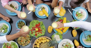 People Clink Juice Glasses, Table With Dishes Of Tropical Fruits And Salad Top Angle View Friends Eating Healthy stock video People Clink Juice Glasses, Table With Dishes Of Tropical Fruits And Salad Top Angle View Friends Eating Healthy stock video