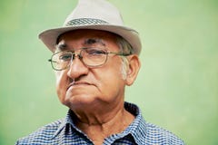 Portrait of serious old man with hat looking at camera stock photography Portrait of serious old man with hat looking at camera stock photography