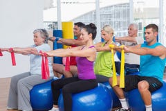 People exercising with resistance bands in gym stock photography People exercising with resistance bands in gym stock photography