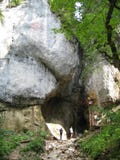 People exploring cave in mountains People exploring cave in mountains