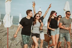 Holidays, vacation. group of friends having fun on beach, walking, drink beer, smiling and hugging stock photos Holidays, vacation. group of friends having fun on beach, walking, drink beer, smiling and hugging stock photos