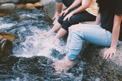 People In Jeans With Feet In Water Royalty Free Stock Photography People In Jeans With Feet In Water Royalty Free Stock Photography
