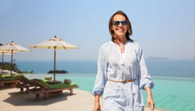 Happy woman walking over infinity edge pool royalty free stock photo Happy woman walking over infinity edge pool royalty free stock photo