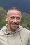 People and lifestyle concept. Happy middle-aged unshaven man with cheerful smile outdoor against green nature background, portrait Royalty Free Stock Image People and lifestyle concept. Happy middle-aged unshaven man with cheerful smile outdoor against green nature background, portrait Royalty Free Stock Image