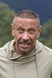 People and lifestyle concept. Happy middle-aged unshaven man outdoor against green nature background, portrait close up Royalty Free Stock Images People and lifestyle concept. Happy middle-aged unshaven man outdoor against green nature background, portrait close up Royalty Free Stock Images