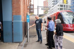People are in line to tap on opal card to get in a tram at Hay stock photos People are in line to tap on opal card to get in a tram at Hay stock photos