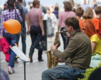 People listen to a street musician