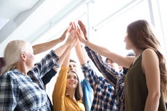 People putting hands together indoors. Unity concept stock photo People putting hands together indoors. Unity concept stock photo