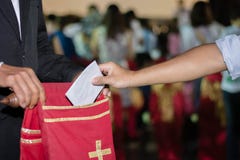 People putting tithing into Velvet offering bag in church royalty free stock photos People putting tithing into Velvet offering bag in church royalty free stock photos