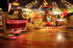People riding carnival ride at night