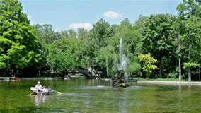 People Rowing The Boat In Cismigiu Gardens In Bucharest. BUCHAREST, ROMANIA - MAY 26: People Rowing The Boat In Cismigiu Gardens In Bucharest on May 26, 2014 in People Rowing The Boat In Cismigiu Gardens In Bucharest. BUCHAREST, ROMANIA - MAY 26: People Rowing The Boat In Cismigiu Gardens In Bucharest on May 26, 2014 in