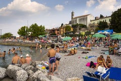 People sunbathing on beach on 30 July 2016 in Desenzano del Garda, Italy. royalty free stock photo People sunbathing on beach on 30 July 2016 in Desenzano del Garda, Italy. royalty free stock photo