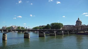 People walking on Pont des Arts bridge on the Seine river - Paris