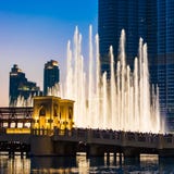People watching Dubai fountains, illuminated trick fountains at night