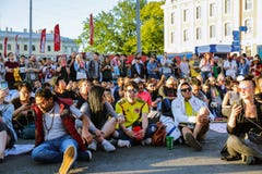 People watching football game on large screen. Stock Photos People watching football game on large screen. Stock Photos