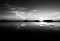 Perfectly symmetrical, beautiful view of Trasimeno lake Umbria, Italy at sunset, with cloud shapes on the sky royalty free stock photos Perfectly symmetrical, beautiful view of Trasimeno lake Umbria, Italy at sunset, with cloud shapes on the sky royalty free stock photos