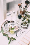 Perfumery and cosmetics on a dressing table in daylight Stock Photos Perfumery and cosmetics on a dressing table in daylight Stock Photos