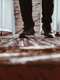 Person in Black-and-white Shoes Standing on Brown Metal Floor Royalty Free Stock Photos Person in Black-and-white Shoes Standing on Brown Metal Floor Royalty Free Stock Photos
