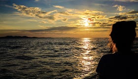 Enjoying the sunset at the coastline stock photo Enjoying the sunset at the coastline stock photo