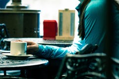 Person in Green Long-sleeved Top Sitting on Chair White Holding White Ceramic Mug Royalty Free Stock Image Person in Green Long-sleeved Top Sitting on Chair White Holding White Ceramic Mug Royalty Free Stock Image