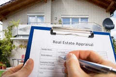 Person Hand Filling Real Estate Appraisal Document