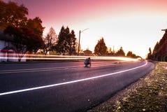Person Sitting on Black Top Road during Twilight Stock Photography Person Sitting on Black Top Road during Twilight Stock Photography