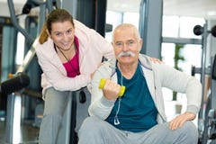 Personal trainer with senior man holding weights royalty free stock photography Personal trainer with senior man holding weights royalty free stock photography