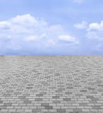 Perspective View of Monotone Gray Brick Stone Street Road. Sidewalk, Pavement Texture Background with Blue Sky and Cloud royalty free stock photography Perspective View of Monotone Gray Brick Stone Street Road. Sidewalk, Pavement Texture Background with Blue Sky and Cloud royalty free stock photography