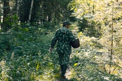 Pessoa na roupa da camuflagem com uma cesta fotografia de stock Pessoa na roupa da camuflagem com uma cesta fotografia de stock