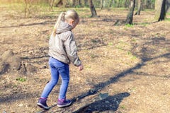 Petite fille blonde caucasienne mignonne marchant sur l'enfant adorable de forêt en bois d'ouverture ayant l'amusement pendant la image stock Petite fille blonde caucasienne mignonne marchant sur l'enfant adorable de forêt en bois d'ouverture ayant l'amusement pendant la image stock