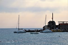 Petrovac, Montenegro, June 2015. Boats and yachts at the pier of the old fortress at sunset. stock photos Petrovac, Montenegro, June 2015. Boats and yachts at the pier of the old fortress at sunset. stock photos