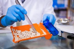 Pharmacist putting pills in container royalty free stock image Pharmacist putting pills in container royalty free stock image