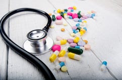 Pharmacy background on a white table. Stethoscope on a white wooden background. Copy space for a text. Tablets on a white backgrou royalty free stock photos Pharmacy background on a white table. Stethoscope on a white wooden background. Copy space for a text. Tablets on a white backgrou royalty free stock photos