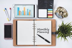 Phone,digita ltablet,cock,blank notebook with MONTHLY PLANNING word stock photography Phone,digita ltablet,cock,blank notebook with MONTHLY PLANNING word stock photography