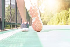 Young woman Jogging in the park in the morning under warm sunlig stock images Young woman Jogging in the park in the morning under warm sunlig stock images