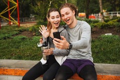 Photo of cheerful sporty couple man and woman 20s in sportswear, Stock Images Photo of cheerful sporty couple man and woman 20s in sportswear, Stock Images