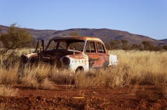 Photo of Corroded Vintage White and Red Sedan on Brown Grass royalty free stock photo Photo of Corroded Vintage White and Red Sedan on Brown Grass royalty free stock photo