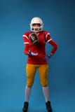 Photo of full length american football player in studio